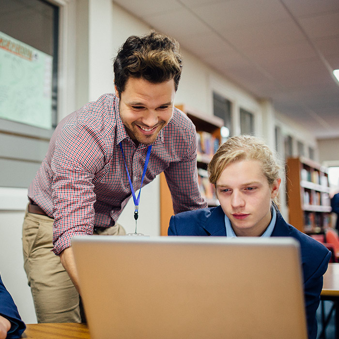 teacher assisting student